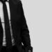 close up black and white image of a person in a smart suit